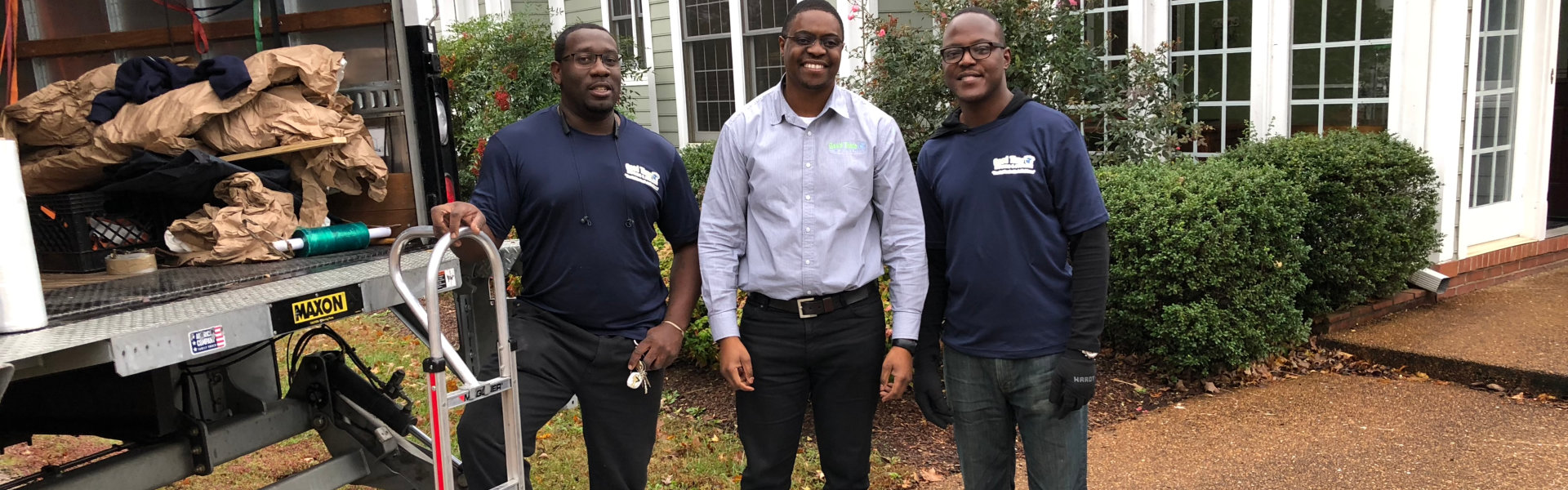 3 men standing after moving packages